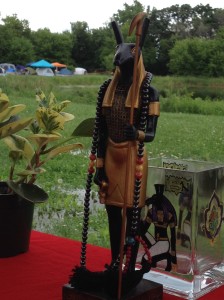 Detail of my Beloved adorned with His hematite prayer beads and surrounded by various ritual accoutrements at His shrine. Again, the ground between my shrine and the low-lying pond evidenced mild flooding on the very first day of the festival.